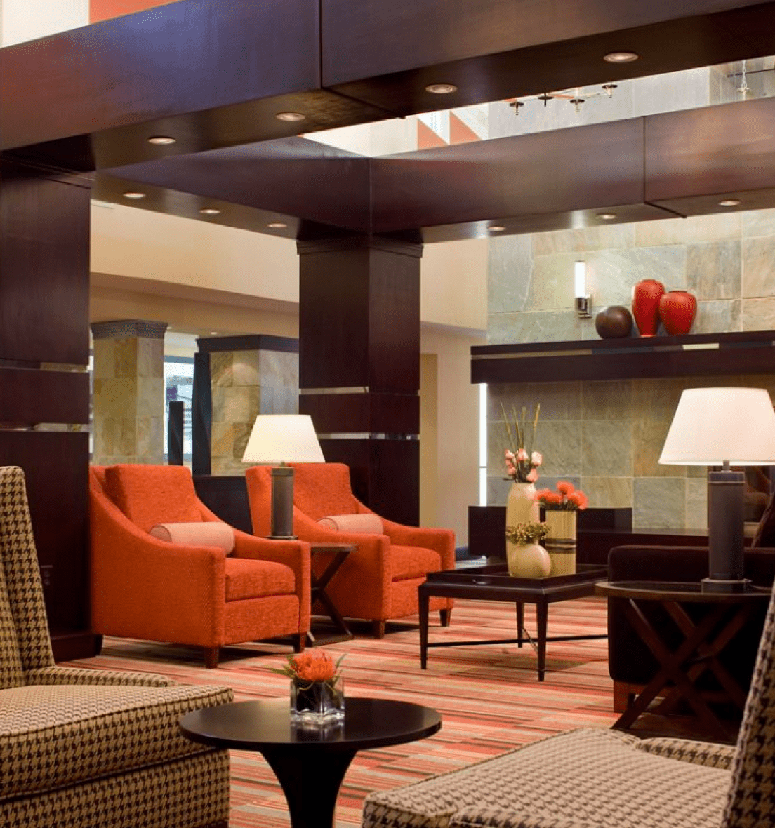 Hotel lobby area with red accent chairs